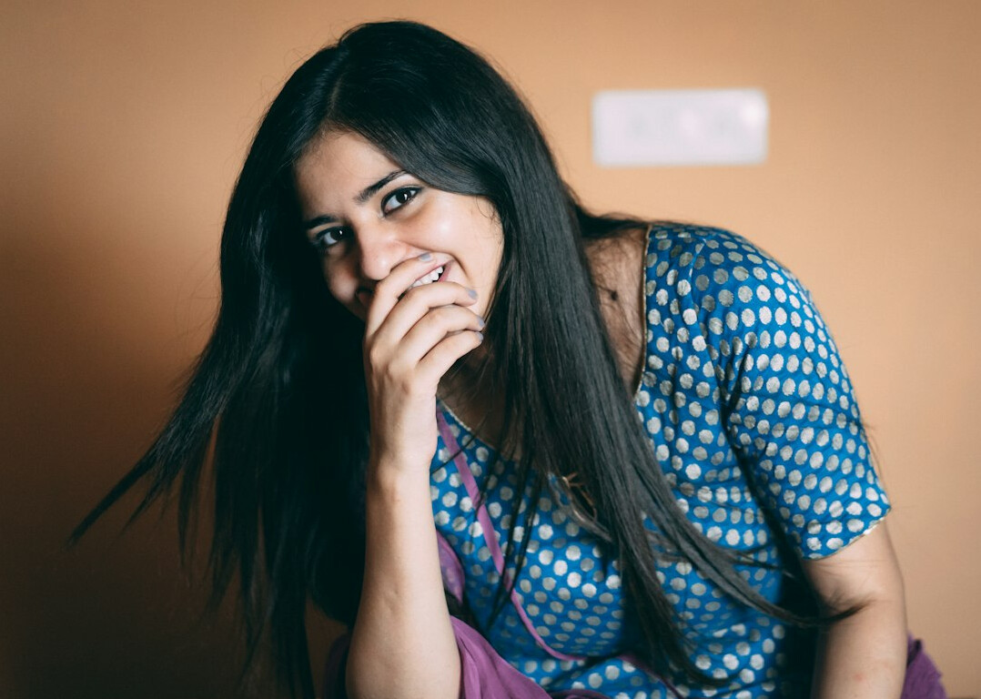 Portrait of a young woman with long hair smiling